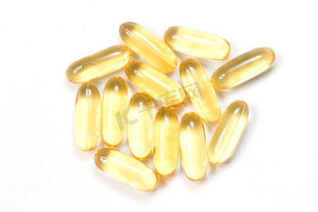 软胶囊中金黄色油补充剂的特写，健康产品概念