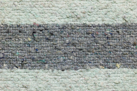 破地毯摄影照片_旧布织物制成的毯子质地。