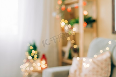 大气时尚背景摄影照片_时尚的圣诞室内装饰与圣诞灯的模糊视图。