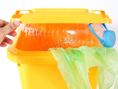 垃圾箱中的黄色垃圾、塑料瓶和绿色袋子