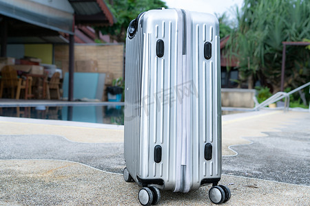 银色旅行行李箱已准备好用于夏季海滩和游泳池
