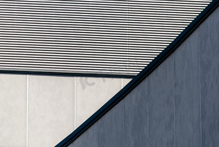 极简蓝色线条摄影照片_条纹墙和混凝土的建筑抽象背景