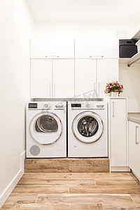 现代风格的洗衣房配有洗衣机和烘干机