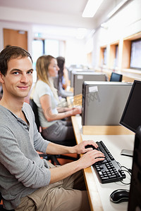一名年轻男学生与电脑合影的肖像