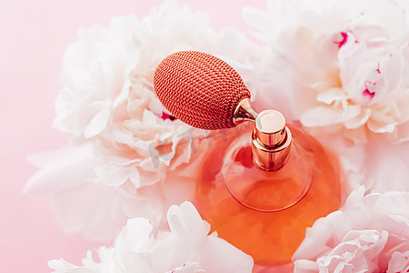 复古香水瓶作为牡丹花背景下的奢华香水产品、香水广告和美容品牌