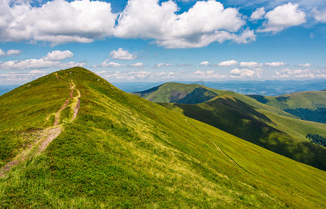 夏天穿过山坡上的草地的小路