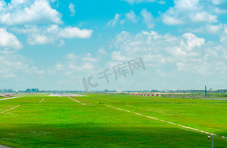 机场跑道和绿草地的景观与蓝天和白云。