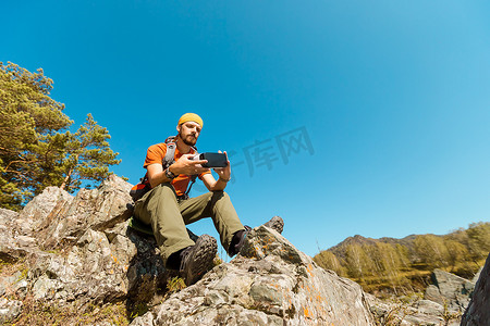 成功的年轻人，使用虚拟现实护目镜在山中游览，夏天度假