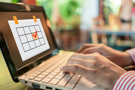 女人手使用笔记本电脑在办公桌上工作学习与计划时间表图标背景。
