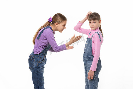 女孩正试图向姐姐解释什么，她困惑地挠着头
