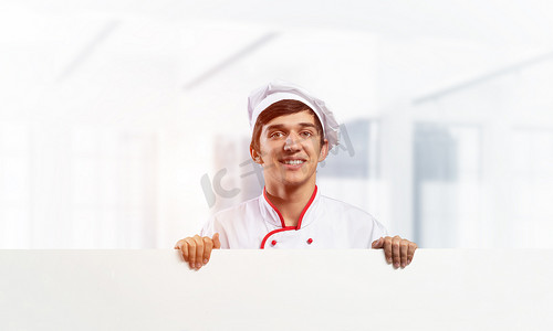 有空白的白色牌的年轻男性厨师