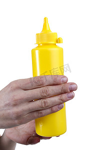 瓶装番茄酱摄影照片_女性手中酱汁的黄色管