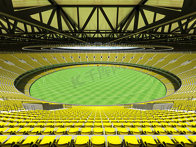 美丽的现代圆形澳大利亚规则足球场，配有黄色座位和 VIP 包厢