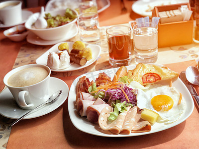 美味的早餐有咖啡、橙汁、鸡蛋、火腿、