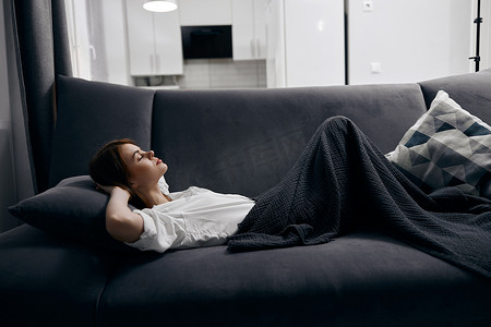 女人躺在沙发上和柔软的枕头内部