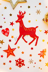 圣诞节和新年背景与闪闪发光的红色木鹿、冷杉树、心脏、雪花和五彩纸屑。