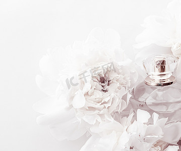 香水广告摄影照片_别致的香水瓶作为牡丹花背景下的奢华香水产品、香水广告和美容品牌