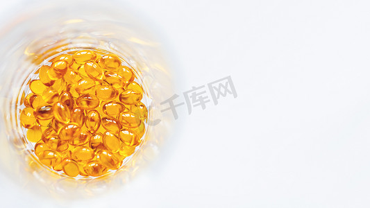 医药产品摄影照片_玻璃罐内的橙色药丸。