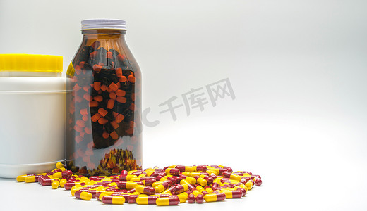 红色、黄色抗生素胶囊药丸和瓶子，白色背景上的耐药性，带复制空间
