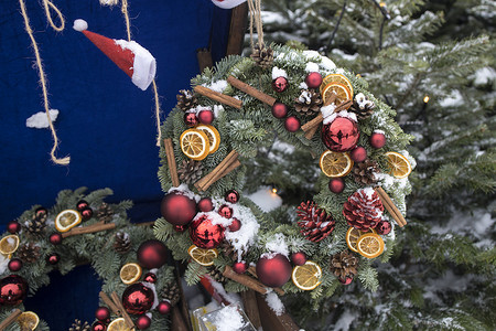 圣诞花环摄影照片_房子墙上挂着装饰的冷杉树枝圣诞花环