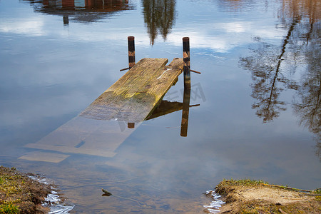 沉没摄影照片_宁静的湖中破旧的沉没码头