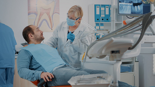 张开嘴的病人接受牙医的检查