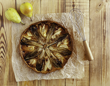菊苣、梨和戈贡佐拉馅饼的烹饪，木质背景，顶视图