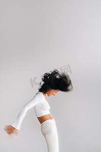 一位身穿白色运动服的女性模糊的轮廓正在瑜伽馆里进行动态卡利冥想