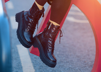 寒冷的日子里，城市街道上穿黑鞋的女人的脚