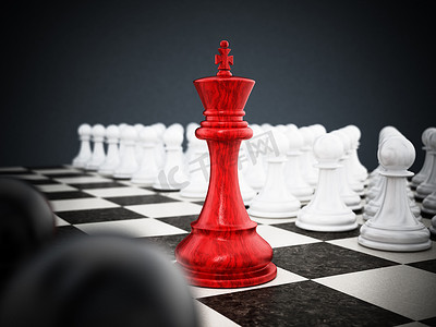 红色国际象棋王站在白色和黑色棋子之间。 