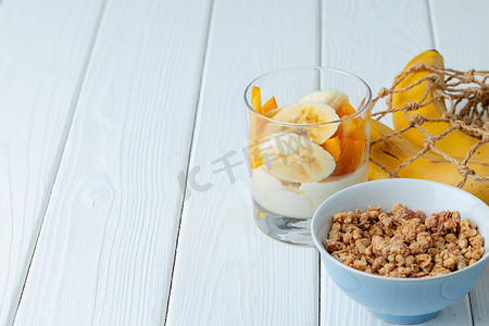 美味的早餐，包括格兰诺拉麦片、酸奶和水果，装在玻璃碗里