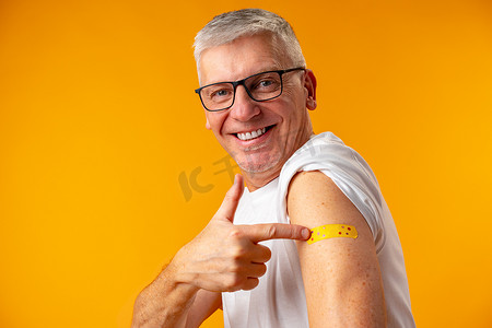 黄背景老人接受了冠状病毒疫苗接种