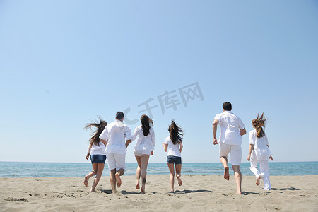 快乐的人群在海滩上玩耍和跑步