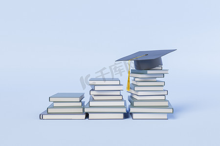 堆书摄影照片_成堆的学习书籍，其中一本戴着毕业帽