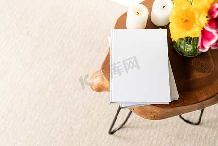 时尚木质咖啡桌上的白书空白封面模型，配有郁金香花束、高角度视图