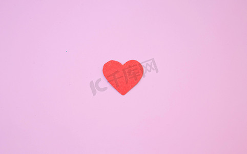 粉色背景上有一颗用纸板剪成的红心
