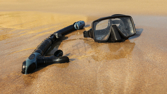 细沙滩上的黑色通气管和潜水镜。