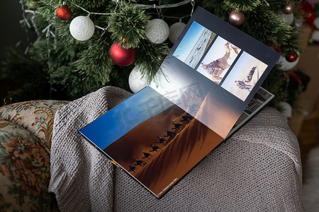 圣诞树下的照片书家庭相册被圣诞礼物包围