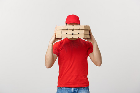 一名送货员躲在他携带的一大堆披萨盒后面。