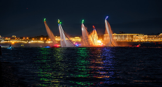 许多飞行板爱好者和穿着鲜艳的喷气式滑雪者晚上在圣彼得堡市中心的一个假期表演他们的表演，水上活动