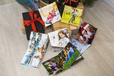 圣诞树附近的照片画布和照片书作为礼物