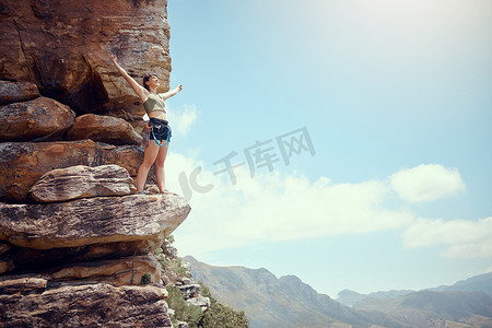 运动徒步蓝色摄影照片_山脉、成功和徒步旅行的女性，可以欣赏自然环境、乡村景观或蓝天背景。