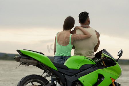 海边情侣摄影照片_海滩上骑摩托车的时尚情侣