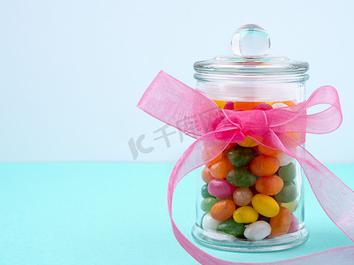 玻璃罐，里面有糖果、糖果，绿松石桌上有粉色丝带的蝴蝶结