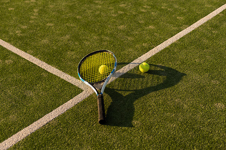 绿草背景上的网球和球拍