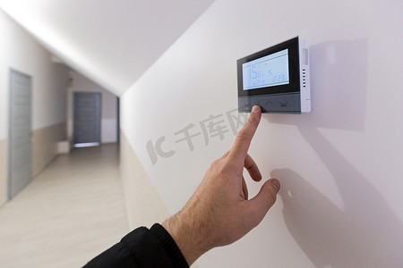 供暖问答摄影照片_公寓和办公室的空调和供暖控制面板位于白墙上