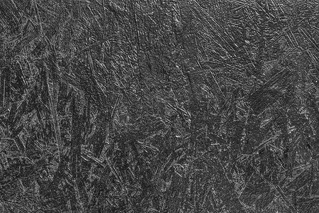 深色压制木刨花板纹理背景的黑漆表面