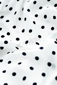 经典圆点纺织背景纹理，白色奢华面料设计图案上的黑点