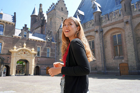 古代女学生摄影照片_参观荷兰海牙 Binnenhof 建筑群的年轻女学生