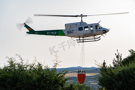 水袋气球摄影照片_带水袋的飞行消防直升机